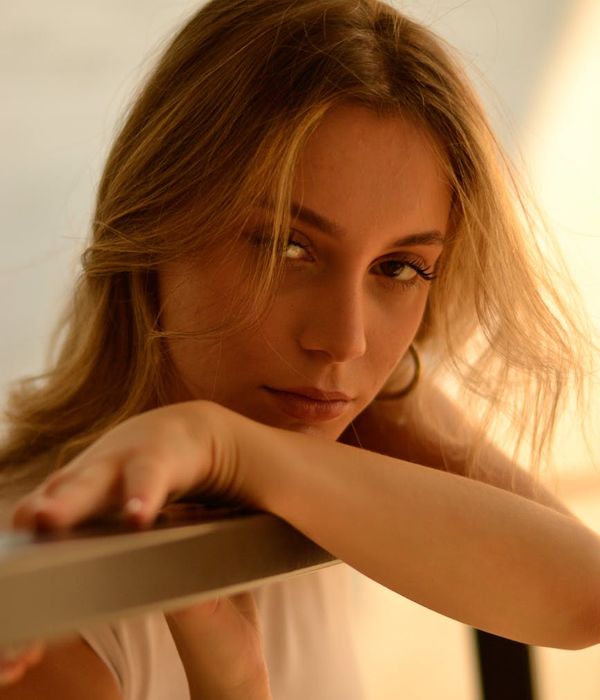 Woman with closed eyes looking serene and relaxed.